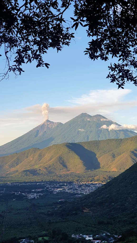 Fuego and Acatenango Volcano at dawn with a large plume of ash above Fuego as it erupts