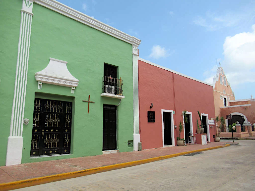 The colourful streets of Valladolid, the town you pass through from Holbox to Chichen Itza. A green and red building are pictured