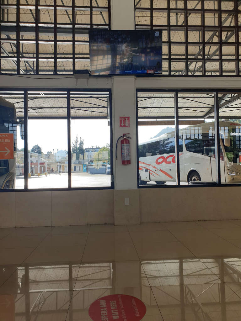 An OCC bus parked at the gate of the ADO bus terminal