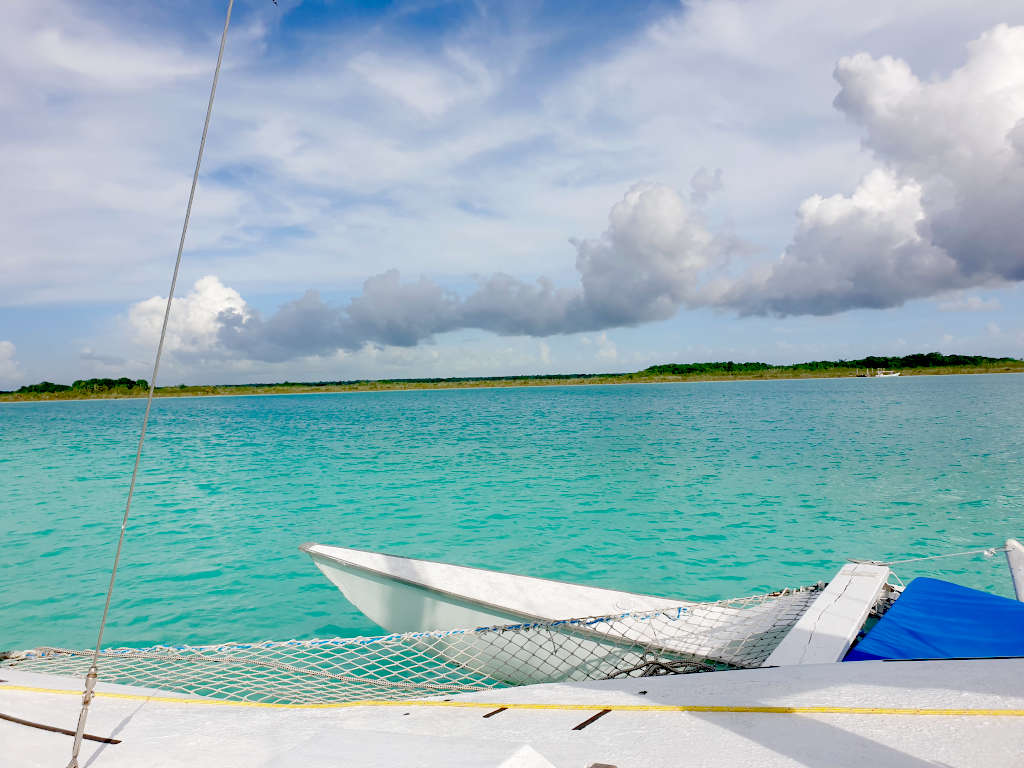 Looking over the vivid colours of the Bacalar lagoon from a sail boat