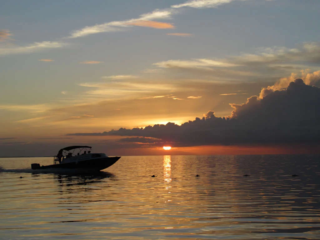 Travel from Belize City to Caye Caulker by plane or boat to reach this Caribbean paradise, with beautiful sunsets and calm seas