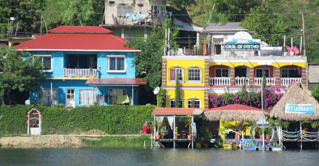 brightly coloured buildings in Flores Guatemala on the water's edge