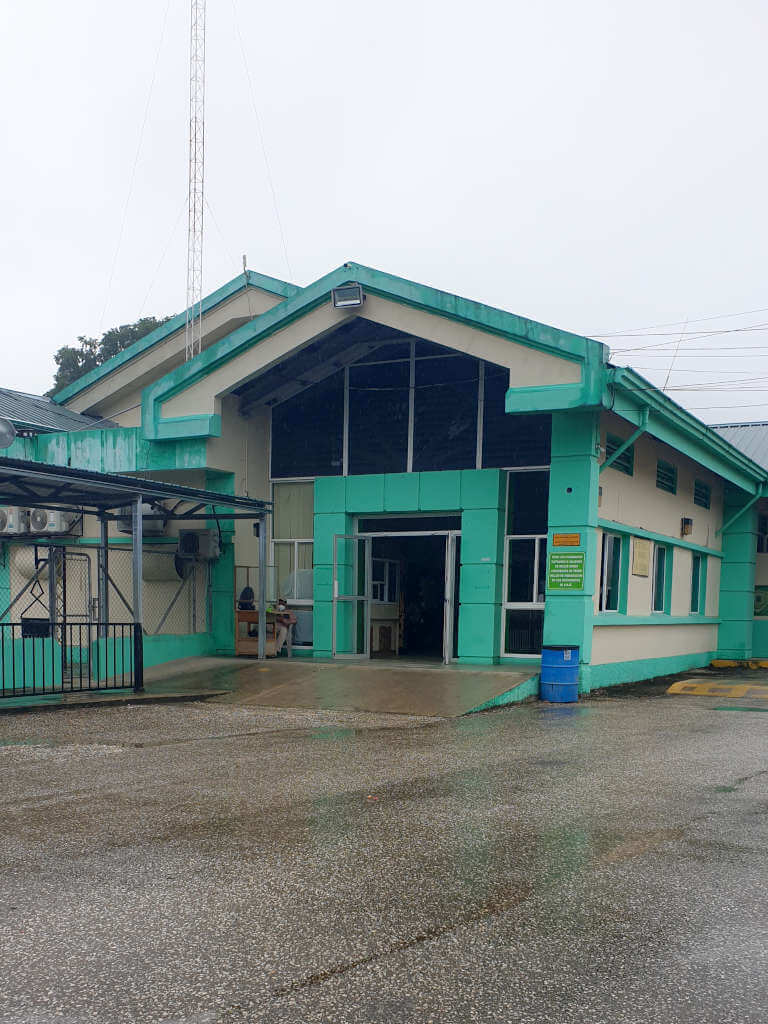 When you go from Flores to Belize City, you'll pass through this Belize Immigration building at Melchor de Mencos. Which is green and cream coloured