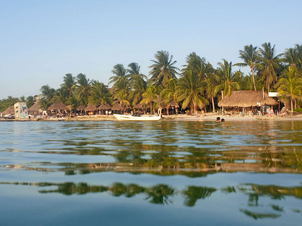 Once you make the journey from Cancun to Holbox, you'll get to swim in these warm seas. Photo taken just above the water line about 20 metres out to sea, looking back at the island that is lined with palm trees