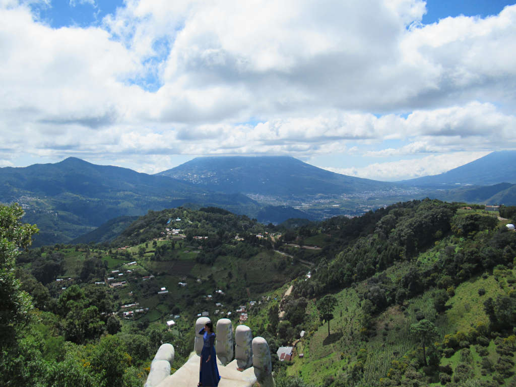 The giant hand of Guatemala at Hobbitenango with the volcanic landscape and lush green hills